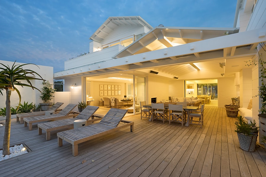 White wooden bench on a deck near a pool