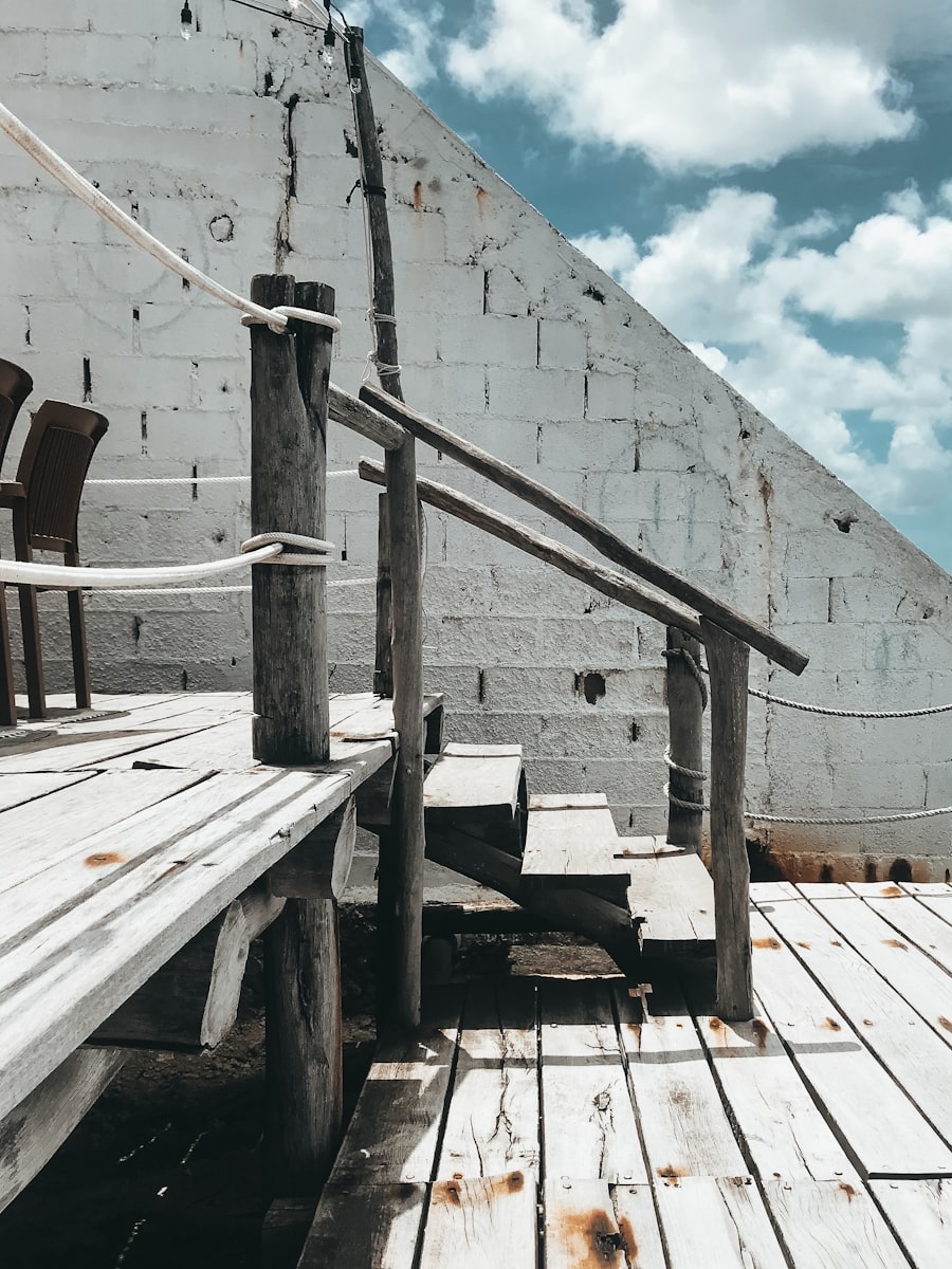 Grey wooden deck stairs with railing