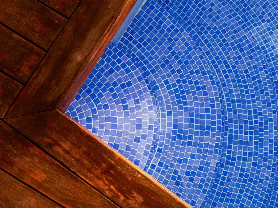 Blue swimming pool bordered by a wooden deck